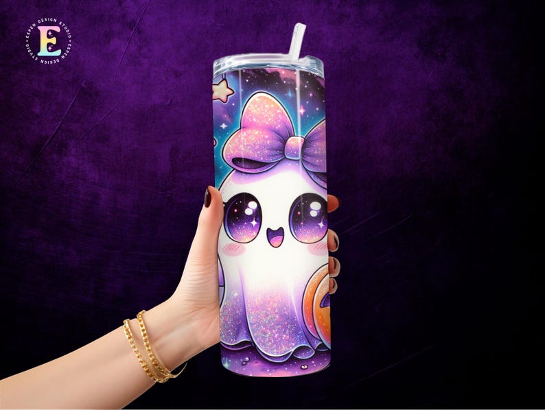 May include: A tall, cylindrical tumbler with a clear lid and straw. The tumbler features a cartoon ghost design with a large bow, starry background, and a jack-o'-lantern. The design is primarily purple, white, and orange.
