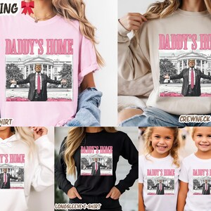 May include: Various apparel items, including t-shirts, sweatshirts, and hoodies, feature a graphic of a man in a suit with the text "DADDY'S HOME". The image is set against a backdrop of a building.