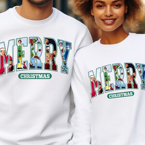 May include: White Christmas themed sweatshirts with the word "Merry" spelled out in large letters. Each letter is made up of a different Christmas movie character. The text "Christmas" appears below the word "Merry".