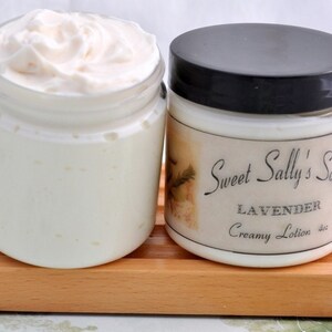 May include: Two jars of white creamy lotion. The jar on the right has a label that reads "Sweet Sally's Soaps Lavender Creamy Lotion 4oz".