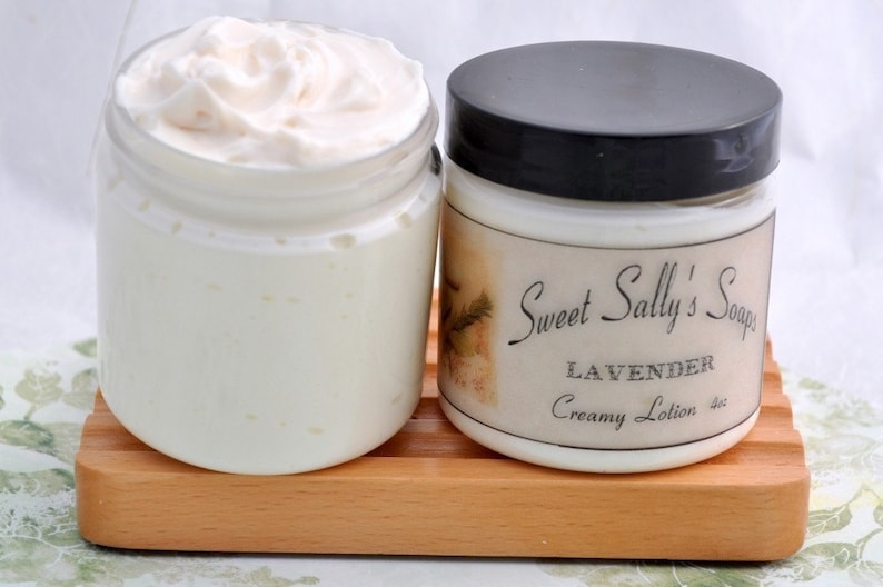 May include: Two jars of white creamy lotion. The jar on the right has a label that reads "Sweet Sally's Soaps Lavender Creamy Lotion 4oz".
