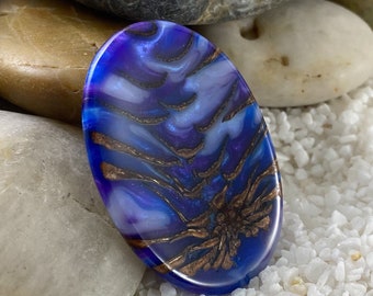 Worry stone handcrafted from pine cones and resin