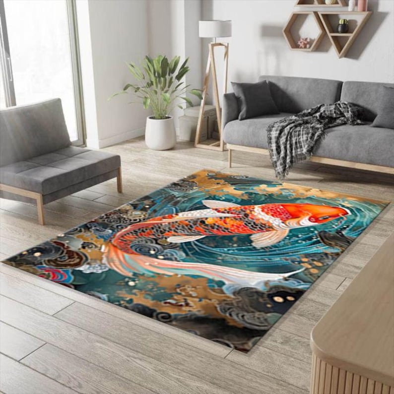May include: A colorful area rug with a large orange and white koi fish swimming in a blue and gold water design. The rug has a traditional Japanese style.