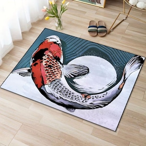 May include: A colorful rug with a large koi fish design. The fish is red, white, and black and is swimming in a circle. The background of the rug is a dark blue with white swirls.