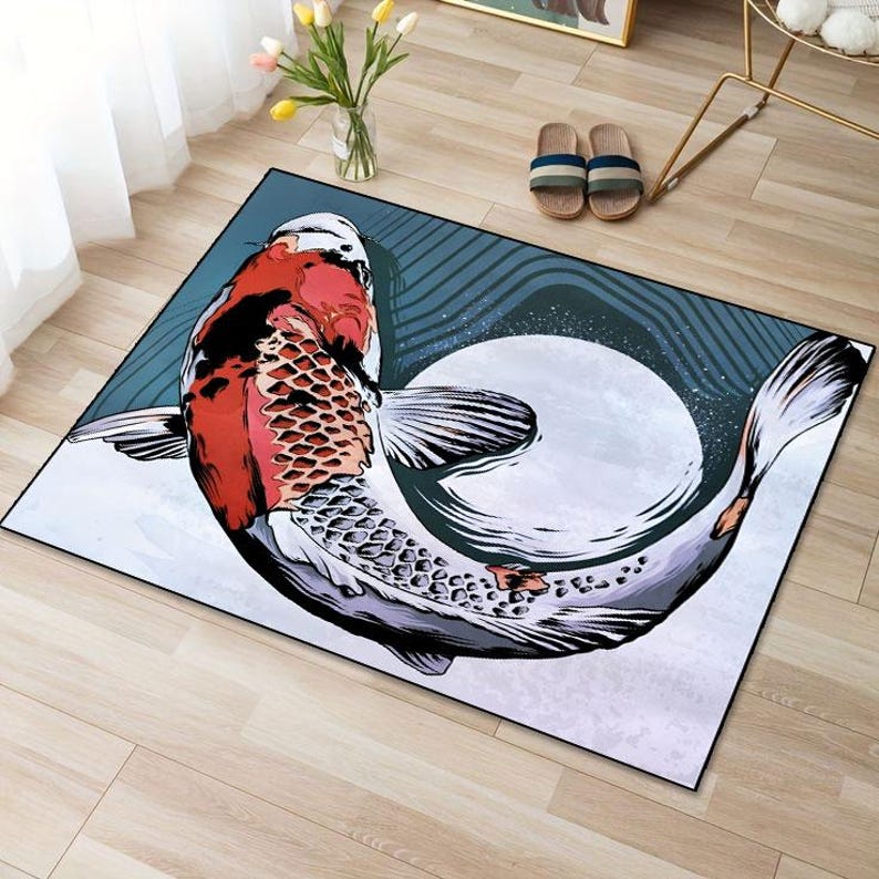 May include: A colorful rug with a large koi fish design. The fish is red, white, and black and is swimming in a circle. The background of the rug is a dark blue with white swirls.