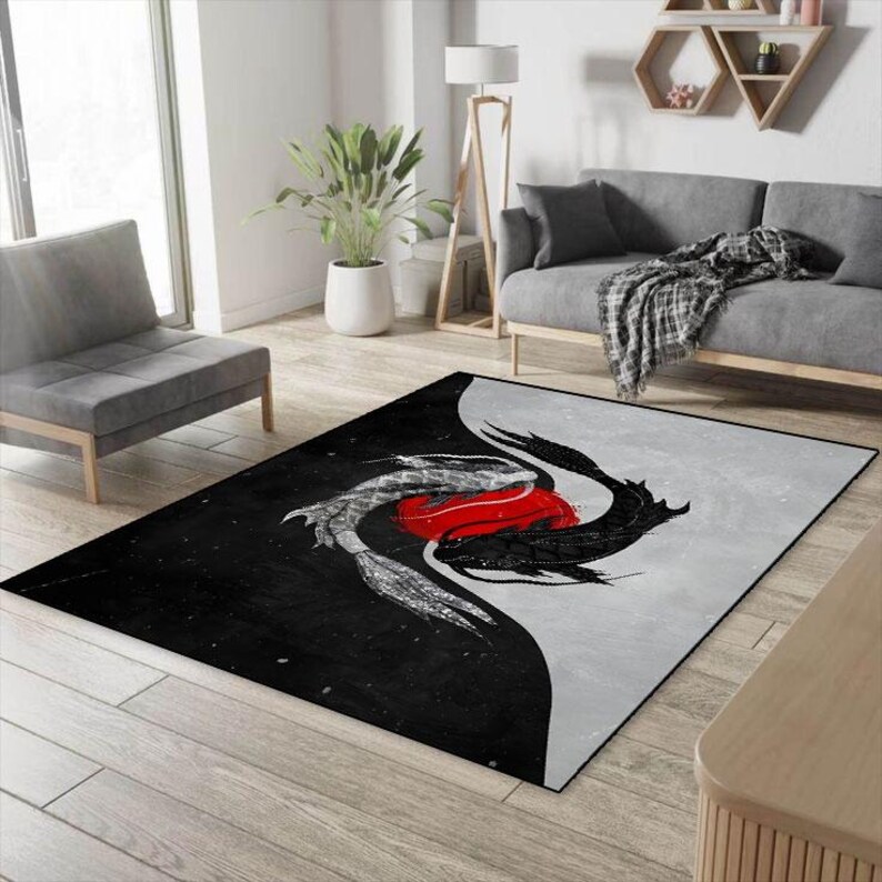 May include: Black and white area rug with a yin yang design featuring two stylized fish, one black and one white, with a red circle in the center.