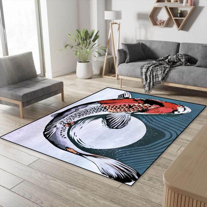 May include: A blue and white area rug with a large, colorful koi fish design. The rug has a circular pattern in the center and a wavy pattern around the edges.