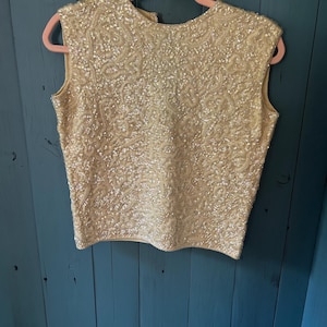 Jersey vintage de los años 50/60, color crema marfil, con lentejuelas, 100% lana, mangas cortas / Talla mediana. Hecho en Hong Kong - Alexander’s