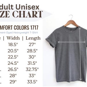 May include: Size chart for a unisex t-shirt in various sizes from S to 4XL. The chart shows the width and length measurements in inches for each size. The chart is labelled "Comfort Colors 1717 Garment-Dyed Heavyweight T-Shirt".