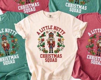 May include: Several t-shirts in cream, red, and teal. Each shirt has a Christmas-themed design with a nutcracker, the text "A Little Nutty", and "Christmas Squad". Ideal for the festive season.