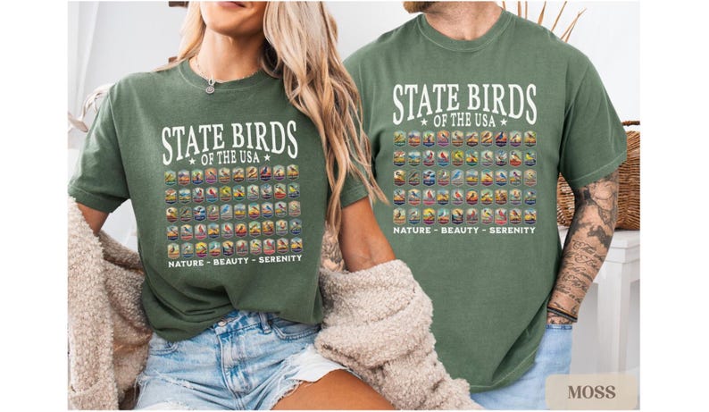 May include: Two green t-shirts with a white graphic of the state birds of the USA. The graphic includes the name of each bird and its state. The text below the graphic reads "Nature - Beauty - Serenity".