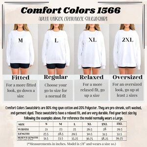 Op de afbeelding: Witte Comfort Colors 1566 unisex crewneck sweatshirts voor volwassenen in de maten M, L, XL en 2XL. De afbeelding bevat een maattabel met afmetingen in inches en richtlijnen voor de pasvorm: getailleerd, normaal, relaxed en oversized. De sweatshirts zijn gemaakt van 80% ringgesponnen katoen en 20% polyester.
