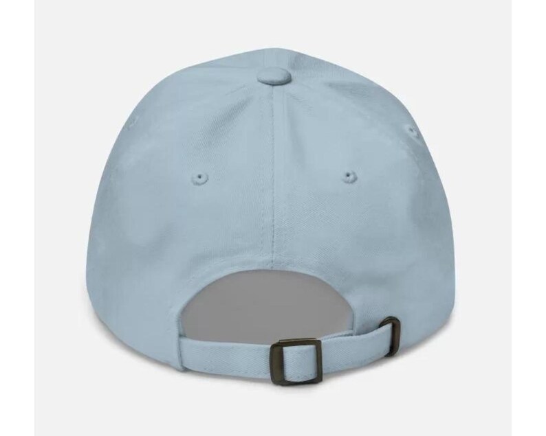 May include: A light blue baseball cap with a brown adjustable strap.