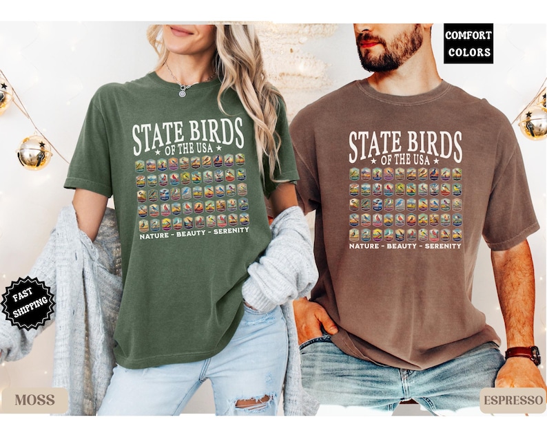 May include: Two t-shirts with a graphic print of the state birds of the USA. The text on the shirts reads "State Birds of the USA" and "Nature - Beauty - Serenity". The shirts are available in moss and espresso colors.