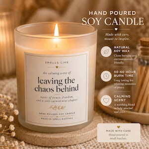 May include: A frosted glass jar soy candle with a lit wick. The label reads: SMELLS LIKE the calming scent of leaving the chaos behind, notes of peace, freedom, and a well-earned next chapter. Text on the right highlights natural soy wax, 50-60 hour burn time, and calming scent.