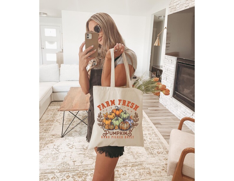 May include: A white tote bag with the text "Farm Fresh Pumpkins Hand Picked Daily" and a graphic of pumpkins.