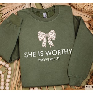 a green shirt with a bow on it