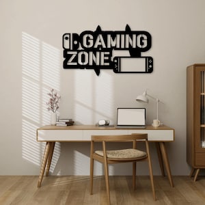 Puede incluir: Decoración de pared de metal negro con el texto "Gaming Zone" y una imagen estilizada de un mando de videojuego.