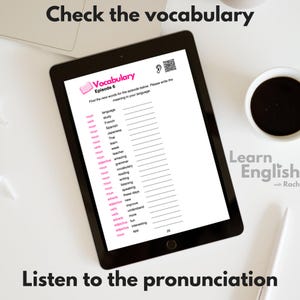 May include: A tablet screen displaying a vocabulary worksheet with the title "Vocabulary Episode 6". The worksheet lists English words with their part of speech and a blank space for the user to write the meaning in their own language. The screen also includes a QR code and a small ear icon. The tablet is on a white surface with a cup of coffee and a pen.