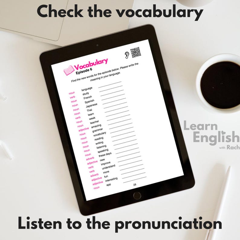 May include: A tablet screen displaying a vocabulary worksheet with the title "Vocabulary Episode 6". The worksheet lists English words with their part of speech and a blank space for the user to write the meaning in their own language. The screen also includes a QR code and a small ear icon. The tablet is on a white surface with a cup of coffee and a pen.