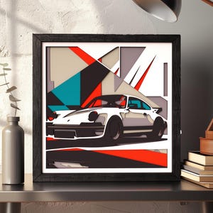 Peut inclure: Une œuvre d'art murale carrée encadrée présentant une illustration en papier découpé superposé d'une voiture de sport blanche. Le design intègre des formes géométriques en rouge, bleu sarcelle, noir et gris, créant un effet multidimensionnel.