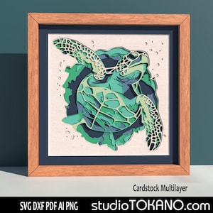 May include: A layered papercraft design of a green sea turtle with a white background. The design is framed in a wooden frame with the text "Cardstock Multilayer" and "studioTOKANO.com" below the frame.
