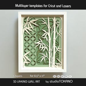 May include: A 3D layered wall art piece in a white frame featuring bamboo stalks and a geometric circular pattern in shades of cream and sage green. The text reads Multilayer templates for Cricut and Lasers, 5 layers, for 8.5" x 11", 3D LAYERED WALL ART, and studioTOKANO.