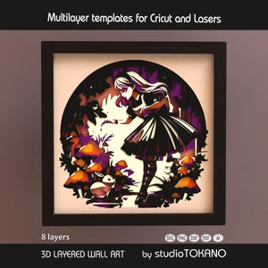 May include: A framed 3D layered wall art piece depicting Alice in Wonderland in black and white, with purple and orange accents. The artwork includes a girl, mushrooms, and a rabbit. The text "Multilayer templates for Cricut and Lasers" is at the top.