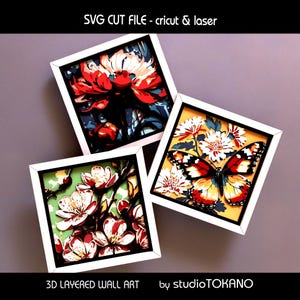May include: Three framed 3D layered wall art pieces. One features a red and white flower, another a butterfly, and the third, white and red flowers. The frames are white, and the background colors vary. Text reads "SVG CUT FILE - cricut & laser" and "3D LAYERED WALL ART by studioTOKANO."