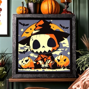May include: A square framed wall art piece featuring a stylized illustration of a scarecrow character wearing a wide-brimmed hat, sitting between two jack-o'-lanterns against a large yellow moon background with black bats in a purple sky.