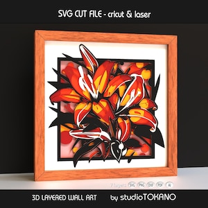 May include: A framed 3D layered wall art piece featuring a vibrant floral design. The artwork showcases red, orange, and yellow lilies with black accents, set against a white background. The frame is a light brown color. Text on the image reads "SVG CUT FILE - cricut & laser" and "3D LAYERED WALL ART".