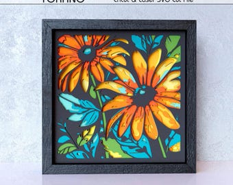 Op de afbeelding: Een vierkante zwarte lijst met een meerlaags papieren kunstwerk met twee grote oranje en gele bloemen met blauwgroene en groene bladeren. De tekst studio TOKANO en Cricut & Laser SVG Cut File staat bovenaan, met 9 LAYER DIGITAL DOWNLOAD onderaan.