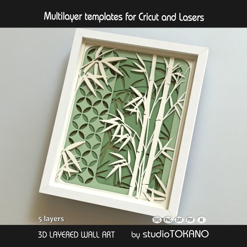 May include: A white framed 3D layered wall art piece featuring a bamboo forest design with five distinct layers. The artwork displays white bamboo stalks and leaves over a green background with a circular geometric pattern. Text reads Multilayer templates for Cricut and Lasers, 5 layers, 3D LAYERED WALL ART, and studioTOKANO.