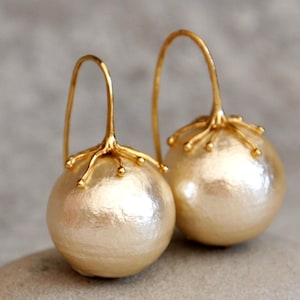 Pendientes grandes de perlas doradas: diseño llamativo con perlas de algodón.