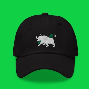 May include: Black baseball cap with a white embroidered bull and a green arrow design. The cap has a curved brim and an adjustable strap at the back. The hat is made of a soft, durable material.
