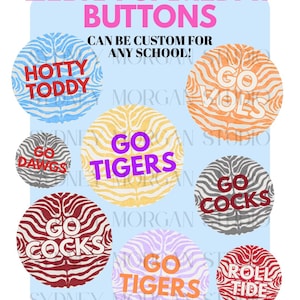 May include: A collection of circular buttons featuring zebra stripe patterns in various colors. Text on the buttons includes HOTTY TODDY, GO VOLS, GO DAWGS, GO TIGERS, GO COCKS, and ROLL TIDE. The header text reads ZEBRA GAMEDAY BUTTONS CAN BE CUSTOM FOR ANY SCHOOL!