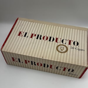 May include: A rectangular box with a striped beige and white pattern. The box has red edges and the words "EL PRODUCTO" in red and black. The box also has the text "50 Cigars" and "Blunts". A gold emblem is in the center.