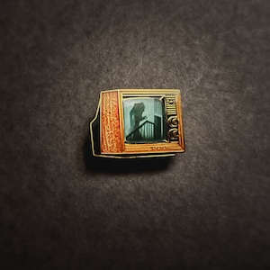 Woodgrain Television Glow In The Dark Enamel Pin with Pre-Installed "Nosferatu On The Stairs"