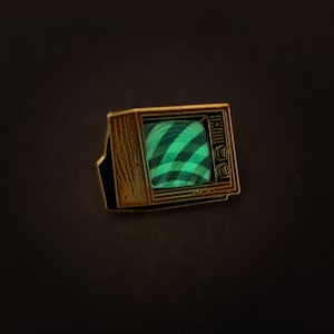 Woodgrain Television Glow In The Dark Enamel Pin with Pre-Installed "Mysterious Swirls"