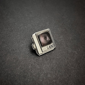 Silver TV Glow In The Dark Enamel Pin with Pre-Installed "Peephole"