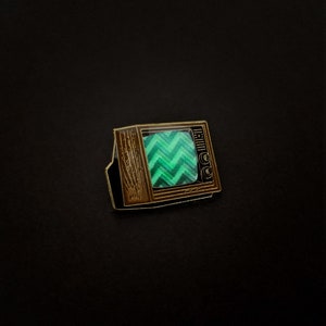 Woodgrain Television Glow In The Dark Enamel Pin with Pre-Installed "Chevron"