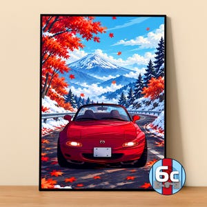 May include: A framed vertical art print featuring a red convertible sports car driving on a winding road. The background displays a snow-covered mountain landscape with vibrant red autumn maple leaves falling under a bright blue sky.