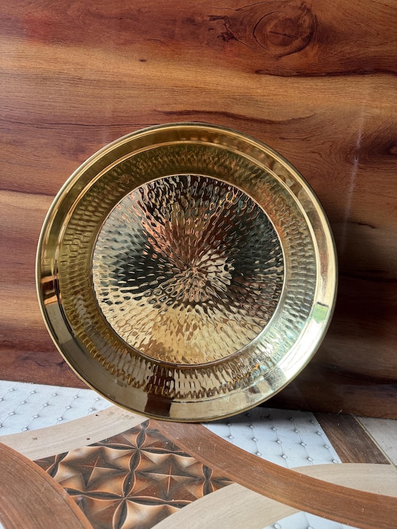 A hand-hammered traditional Indian brass parat — a centuries-old utensil form made by artisans, beautiful as both a working tray and wall decor.