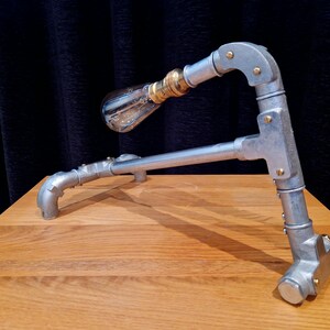 Mechanical style steampunk inspired industrial lamp made from galvanised steel pipe