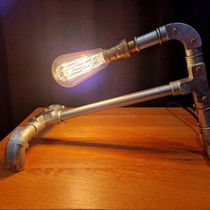 Mechanical style steampunk inspired industrial lamp made from galvanised steel pipe