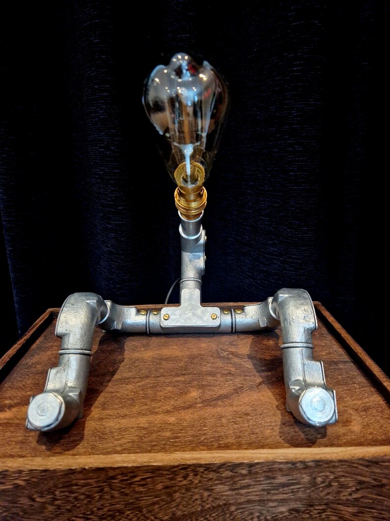 Steampunk Pipe light made from galvanised conduit in a Pipe Man robot style.