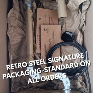 Hand-wrapped industrial lamp packaging featuring thick recycled kraft paper, traditional rustic brown twine, and a hand-inked artisan tag. Minimalist, eco-friendly presentation for a Sheffield made studio item.