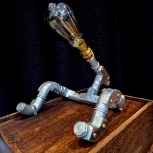 Steampunk Pipe light made from galvanised conduit in a Pipe Man robot style.