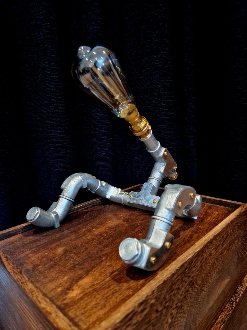 Steampunk Pipe light made from galvanised conduit in a Pipe Man robot style.