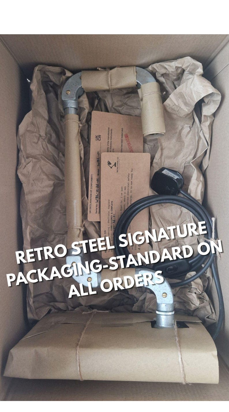 May include: A retro steel product is packaged in a cardboard box with brown paper and twine. The product is wrapped in brown paper. The text "RETRO STEEL SIGNATURE PACKAGING-STANDARD ON ALL ORDERS" is visible.